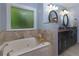 Bathroom features a soaking tub, granite countertops, and and sinks at 2111 Yorkshire Ct, Woodstock, GA 30189