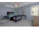 Relaxing bedroom offers soft carpet, ceiling fan, a bed, and plenty of natural light from the windows at 2111 Yorkshire Ct, Woodstock, GA 30189