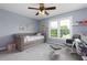 Serene bedroom features a daybed, soft carpet, a ceiling fan, and natural light from the windows at 2111 Yorkshire Ct, Woodstock, GA 30189
