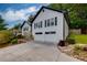 Charming home featuring a two-car garage, front yard landscaping and a welcoming entrance at 2111 Yorkshire Ct, Woodstock, GA 30189