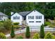 Charming home featuring a two-car garage, front yard landscaping and a welcoming entrance at 2111 Yorkshire Ct, Woodstock, GA 30189