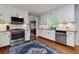 Bright kitchen with stainless steel appliances, white cabinets, granite countertops, and hardwood floors at 2111 Yorkshire Ct, Woodstock, GA 30189