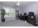 Comfortable home office with natural light, neutral carpet, and ample space for a desk and shelving at 2111 Yorkshire Ct, Woodstock, GA 30189