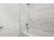 A clean white bathtub with marble-look tiling and shower-head at 2959 Pritchards Mill Trl, Douglasville, GA 30135