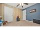 Bedroom with ceiling fan, beige carpet, and pale blue walls with white trim at 2959 Pritchards Mill Trl, Douglasville, GA 30135