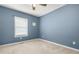 This carpeted bedroom with a window provides a cozy personal space at 2959 Pritchards Mill Trl, Douglasville, GA 30135