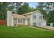 Two-story home featuring light siding, stone accents, attached garage, and a well-manicured front lawn at 2959 Pritchards Mill Trl, Douglasville, GA 30135