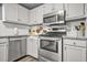 Bright kitchen with stainless steel appliances, granite countertops, and modern white cabinetry at 2959 Pritchards Mill Trl, Douglasville, GA 30135