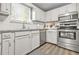 Well-lit kitchen featuring stainless steel appliances, white cabinets, and stylish countertops at 2959 Pritchards Mill Trl, Douglasville, GA 30135