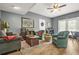 Relaxing living room featuring wood floors, comfortable seating, and direct access to the back patio at 2959 Pritchards Mill Trl, Douglasville, GA 30135