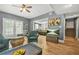 Spacious living room featuring wood floors, direct access to the back patio, and views to another seating area at 2959 Pritchards Mill Trl, Douglasville, GA 30135