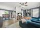 Open-concept living room with wood floors and stairs adjacent to the kitchen and dining areas at 2959 Pritchards Mill Trl, Douglasville, GA 30135