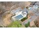 Aerial view features a community pool with mature trees plus residential neighborhood nearby at 3977 Sweet Bottom Dr, Duluth, GA 30096