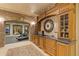 Basement bar with brick accents, custom cabinets, granite counters, and a wine refrigerator for entertaining at 3977 Sweet Bottom Dr, Duluth, GA 30096