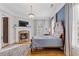 Comfortable bedroom with fireplace, hardwood floors, and natural light from windows at 3977 Sweet Bottom Dr, Duluth, GA 30096