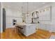 Spacious white kitchen features an island with seating, hardwood floors, and modern stainless steel appliances at 3977 Sweet Bottom Dr, Duluth, GA 30096