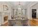 Elegant living room with fireplace, hardwood floors, molding, and natural light at 3977 Sweet Bottom Dr, Duluth, GA 30096