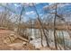 Scenic river view with rock steps leading to the water's edge, surrounded by mature trees and landscaping at 3977 Sweet Bottom Dr, Duluth, GA 30096