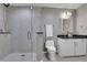 Bathroom showcasing a glass-enclosed shower, white vanity with granite countertop, and modern fixtures at 855 Peachtree Ne St # 1703, Atlanta, GA 30308