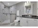 Bathroom features a tiled shower, modern fixtures, and a white vanity with black countertop at 855 Peachtree Ne St # 1703, Atlanta, GA 30308