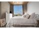 Relaxing bedroom featuring a white bed, neutral tones, and a window offering city views at 855 Peachtree Ne St # 1703, Atlanta, GA 30308