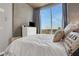 Serene bedroom with a white bed, large window offering views, and minimalist decor at 855 Peachtree Ne St # 1703, Atlanta, GA 30308