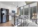 Modern kitchen with stainless steel appliances, mosaic backsplash, and island seating offers a stylish cooking space at 855 Peachtree Ne St # 1703, Atlanta, GA 30308