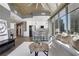 Well-lit living space featuring contemporary decor, oversized windows with city views, and modern kitchen at 855 Peachtree Ne St # 1703, Atlanta, GA 30308