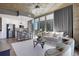 Spacious living area with modern decor, oversized windows, and an open floor plan leading to the kitchen at 855 Peachtree Ne St # 1703, Atlanta, GA 30308