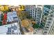 Elevated view of a lush rooftop garden with trees, walkways, and seating areas adjacent to a modern building at 855 Peachtree Ne St # 1703, Atlanta, GA 30308