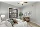 Bright bedroom with modern ceiling fan, neutral color palette, and a large window for natural light at 870 Inman Village Ne Pkwy # 305, Atlanta, GA 30307
