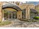 Building entrance with a black awning over glass doors, surrounded by flower beds and green foliage at 870 Inman Village Ne Pkwy # 305, Atlanta, GA 30307