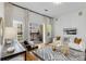 Bright living room boasts natural light from the balcony with a modern sofa and stylish black and white rug at 870 Inman Village Ne Pkwy # 305, Atlanta, GA 30307