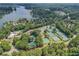 Beautiful aerial view of lake community featuring tennis courts and pools amidst lush greenery and lake access at 1215 Wynridge Xing, Alpharetta, GA 30005