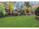 Expansive backyard features lush green grass, manicured landscaping, and mature trees at 1215 Wynridge Xing, Alpharetta, GA 30005
