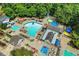Aerial view of a stunning community pool featuring a waterslide, splash pad, and lounge area for the entire Gathering at 1215 Wynridge Xing, Alpharetta, GA 30005