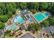 Overhead shot of a community pool featuring waterslide, mushroom fountain, splash pad, lap pool, and lounge area at 1215 Wynridge Xing, Alpharetta, GA 30005