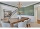 Inviting dining room with a wooden table, chandelier, wainscoting and olive green walls at 1215 Wynridge Xing, Alpharetta, GA 30005