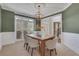 Cozy dining room featuring a wooden table, a chandelier, and paneled wainscoting at 1215 Wynridge Xing, Alpharetta, GA 30005