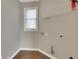 Practical laundry room with a window and shelving, ready for easy organization and efficiency at 1215 Wynridge Xing, Alpharetta, GA 30005