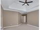 Spacious main bedroom features tray ceilings, ceiling fan, neutral walls, and carpet flooring at 1215 Wynridge Xing, Alpharetta, GA 30005