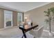 Well-lit office space with a dark wood desk, large windows, and neutral wall color at 1215 Wynridge Xing, Alpharetta, GA 30005