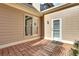 Brick patio featuring neutral siding, exterior lighting, and a door with built-in blinds at 1215 Wynridge Xing, Alpharetta, GA 30005