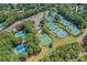 Aerial view of multiple community tennis courts surrounded by mature trees and a parking area at 1215 Wynridge Xing, Alpharetta, GA 30005