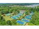 Aerial view of multiple community tennis courts bordered by lush trees at 1215 Wynridge Xing, Alpharetta, GA 30005
