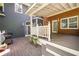 Back porch with white railings, covered ceiling and outdoor grill at 4259 Kings Troop Rd, Stone Mountain, GA 30083