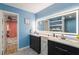 Modern bathroom with double vanities, a large mirror, and a view to an adjacent room at 4259 Kings Troop Rd, Stone Mountain, GA 30083