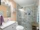 Bathroom features a modern vanity and shower with glass doors and marble walls at 4259 Kings Troop Rd, Stone Mountain, GA 30083