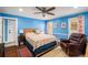 This cozy bedroom features hardwood floors, a ceiling fan and a leather chair at 4259 Kings Troop Rd, Stone Mountain, GA 30083
