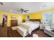 Bright Primary bedroom with a ceiling fan, hardwood flooring, and natural light through windows at 4259 Kings Troop Rd, Stone Mountain, GA 30083
